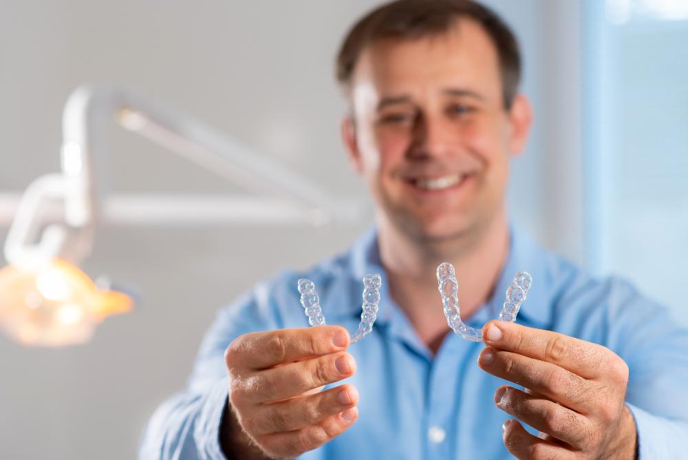 man holding 2 invisalign