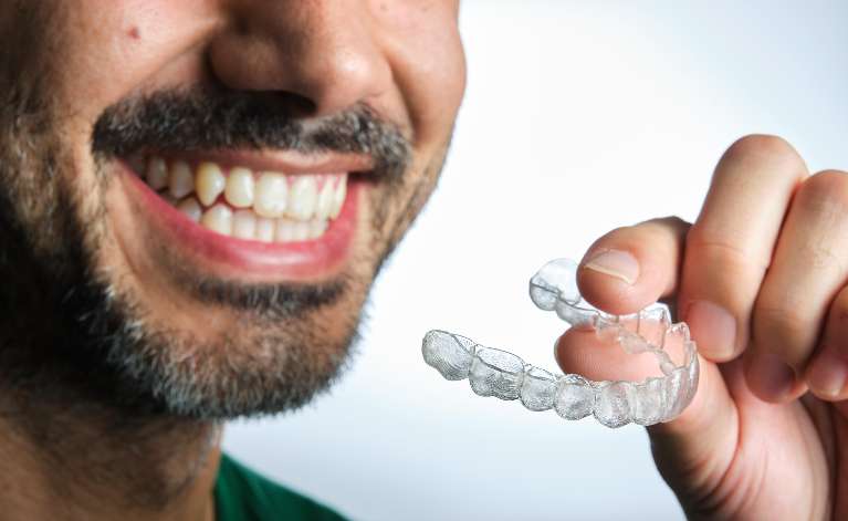 man holding an Invisalign