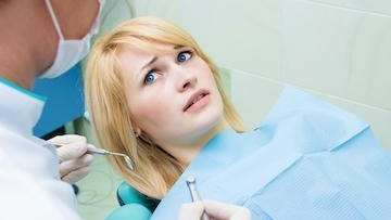 woman with dental anxiety sitting in a dental chair