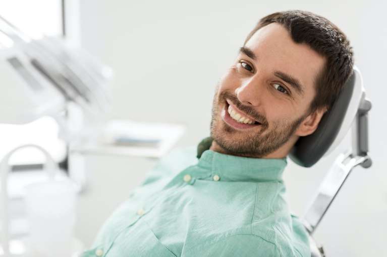 man sitting in a dental chair