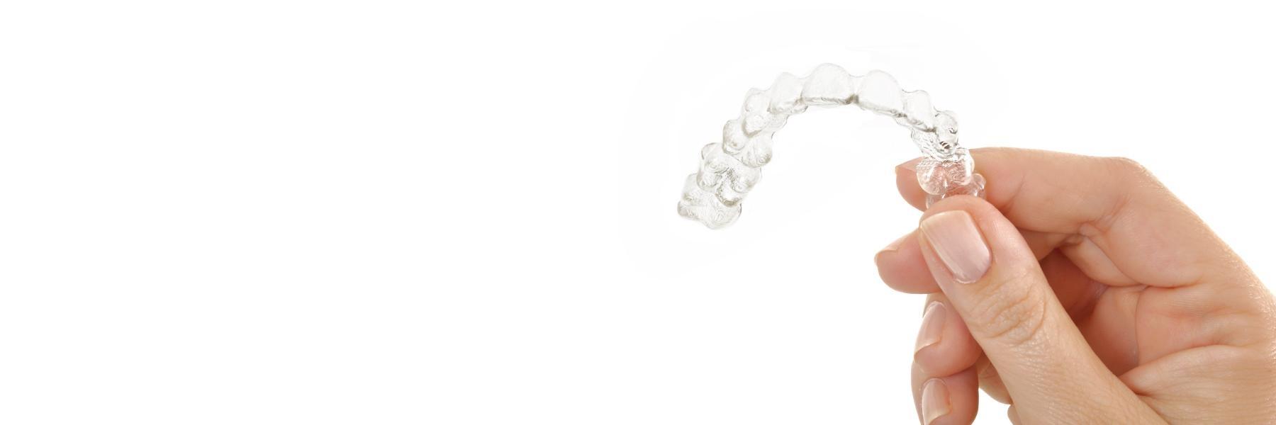 Hand holding Invisalign aligner in Vallejo, CA